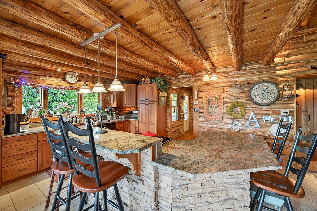 Log cabin kitchen with stone-base island under review